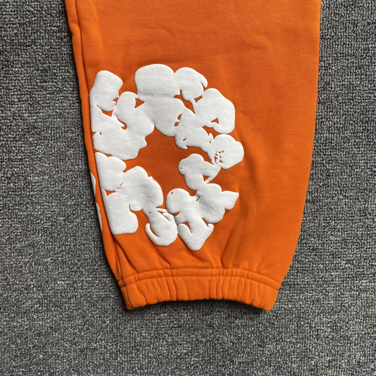 DENIM TEARS COTTON WREATH SWEATPANTS ORANGE - close up - replica sneakers